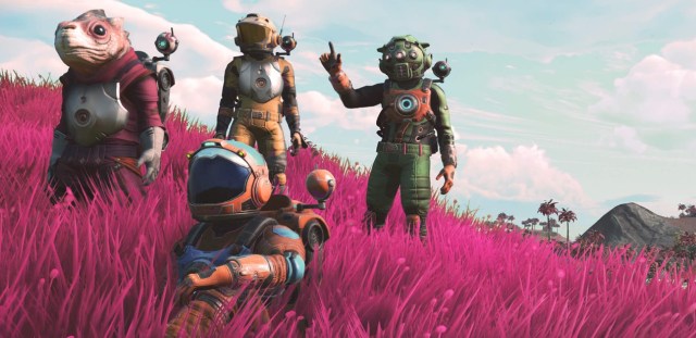 Explorers stand in a pink grassy field in No Man's Sky.