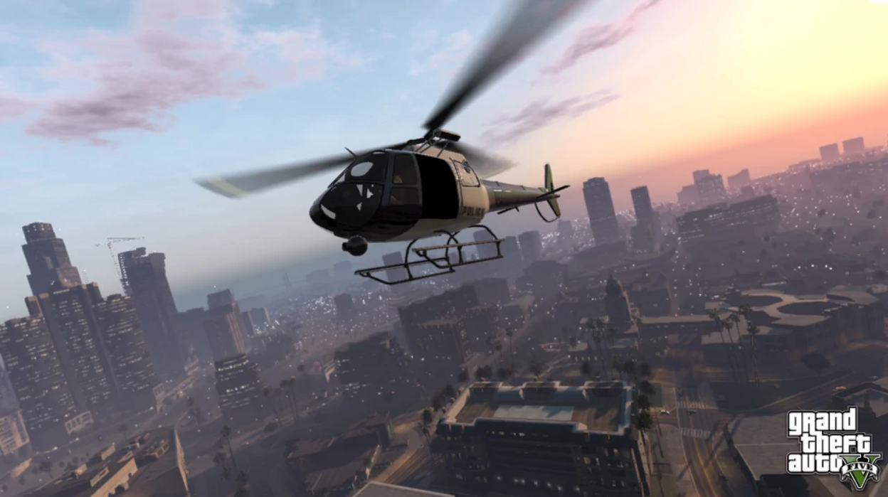 A helicopter flies above a vast cityscape below at sunset.