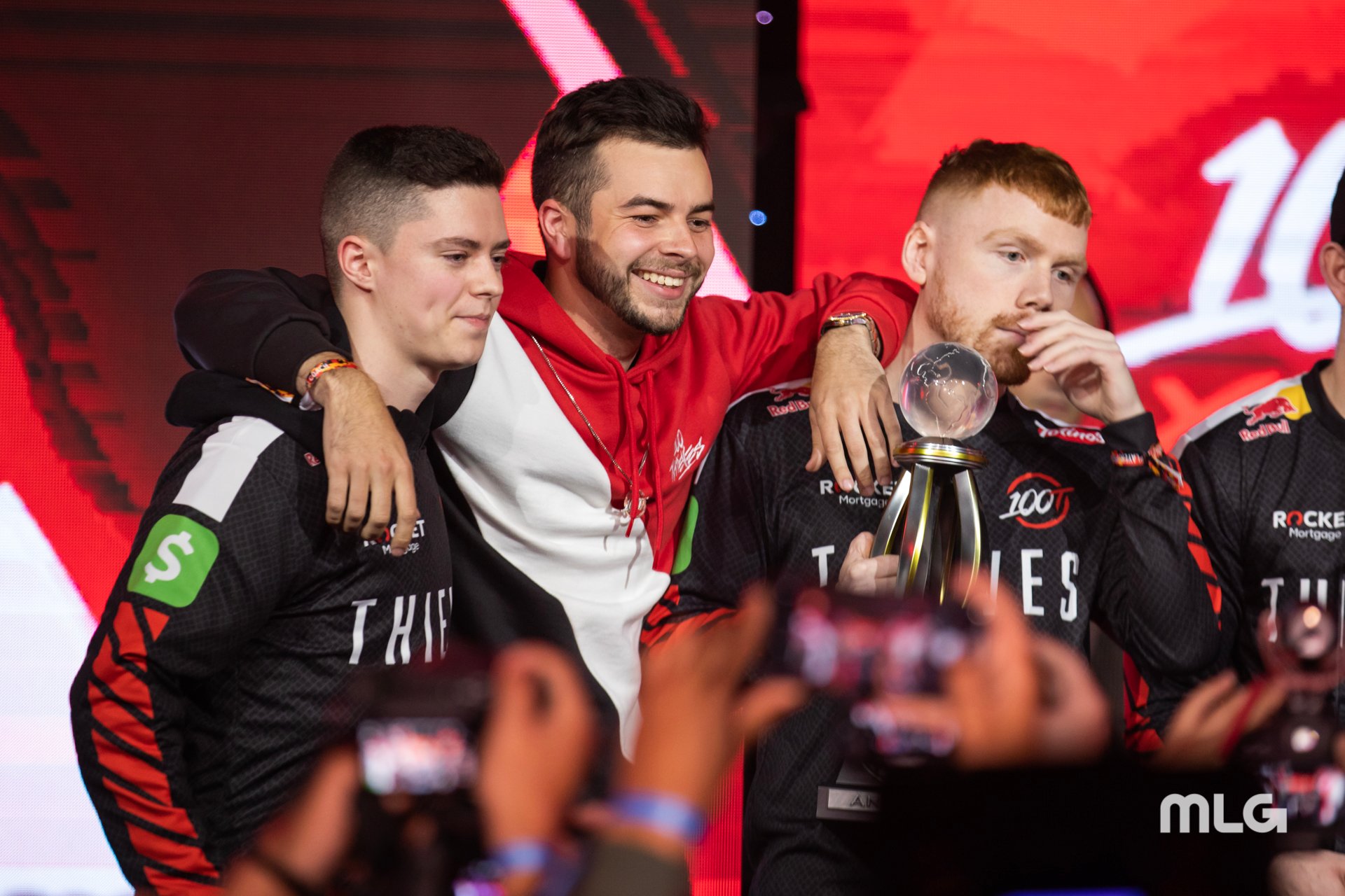 Nadeshot with his arms around CoD pros Enable and Priestahh after 100 Thieves won a CWL tournament.