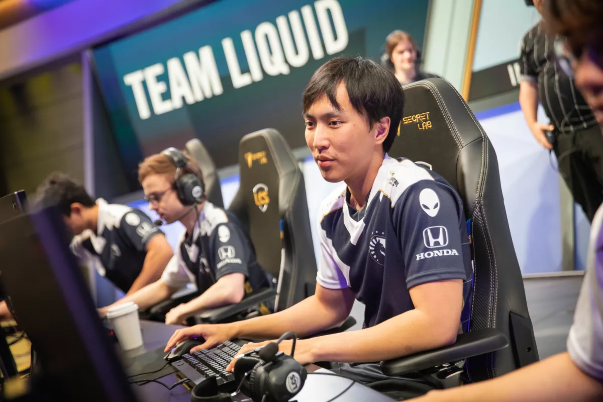 Doublelift sits at his PC playing League of Legends on-stage in the LCS.