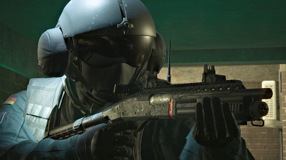 Jager from Rainbow Six Siege stands holding a rifle and looking forward.