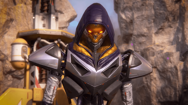 Revenant stares directly at the camera with a dark blue hood pulled up, silver chest and shoulder plates, and a gold faceplate with glowing orange-yellow eyes.