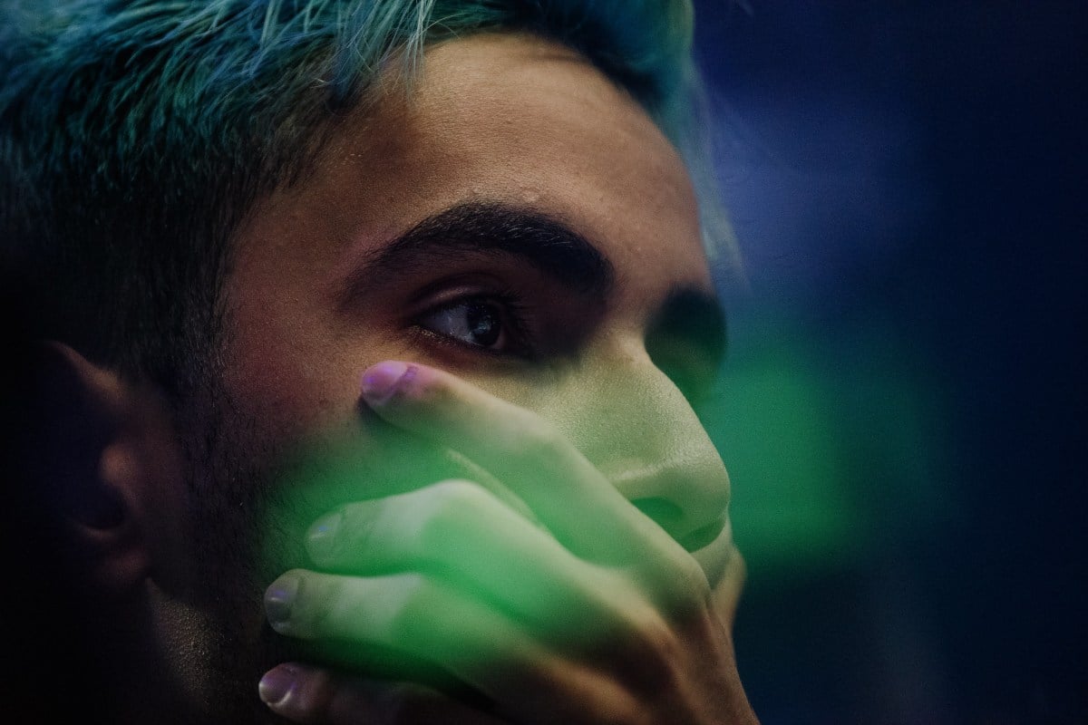 SumaiL covering his mouth on stage at TI8.