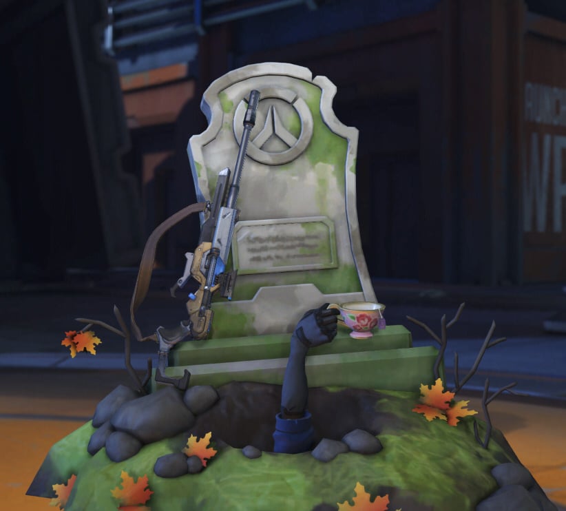 An Overwatch tombstone above a tea cup.