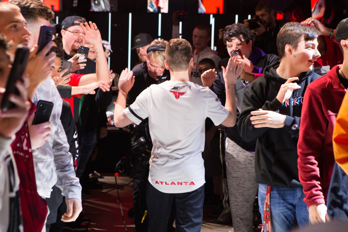 aBezy high-fives with fans at a CDL event.