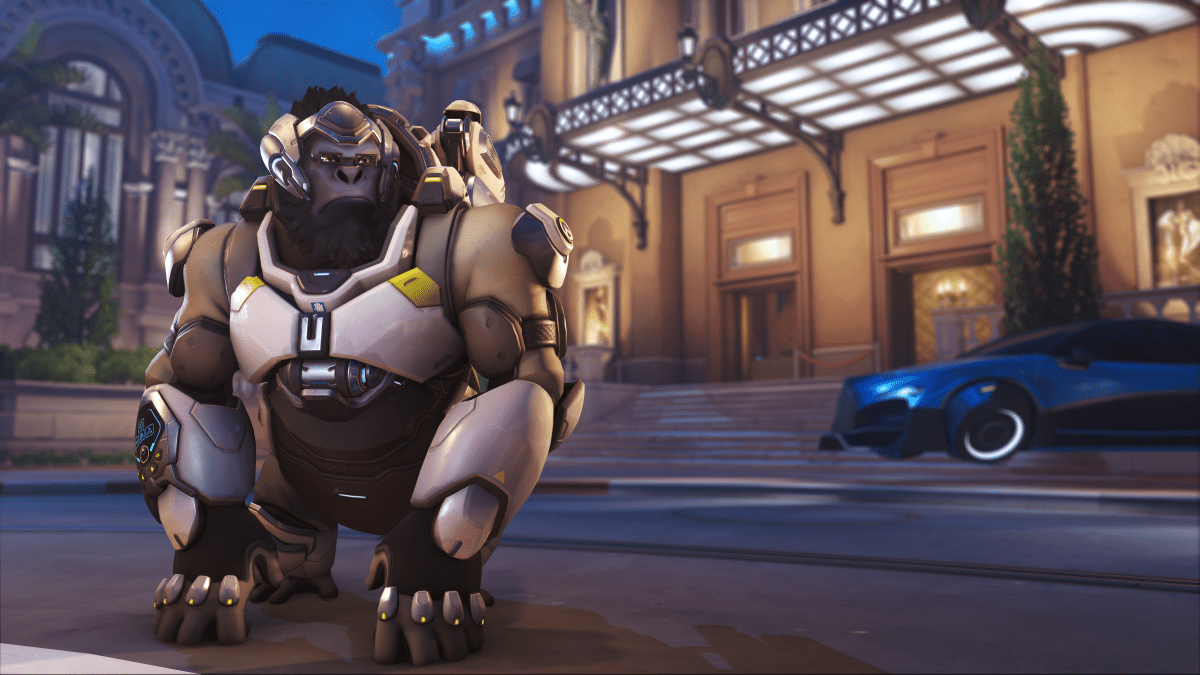 Winston, a large ape, poses squinting outside a city in Overwatch 2.