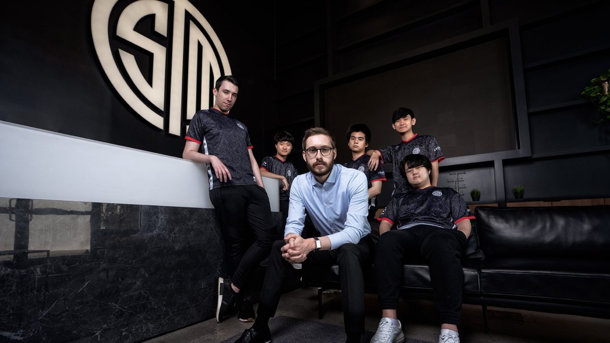 TSM LoL roster posing in front of the logo.