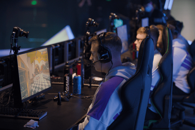 CleanX competing on-stage in the Call of Duty League with the Toronto Ultra, intensely looking at his monitor.