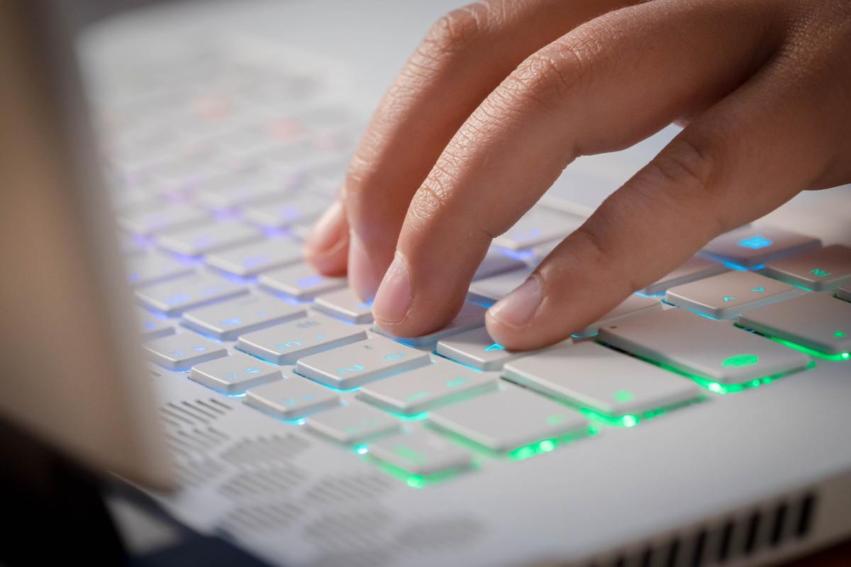 close up of hand typing on keyboard