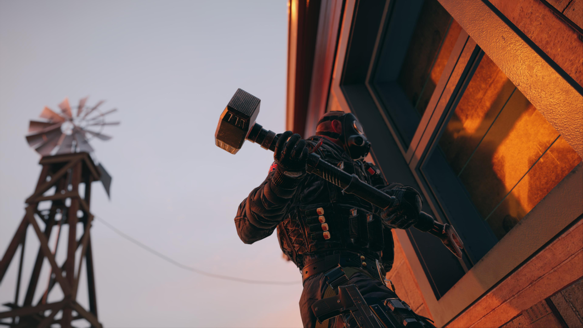 An operator prepares to use a sledgehammer on a house in Rainbow Six Siege.