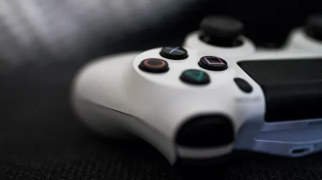 A close-up of a white PlayStation controller.