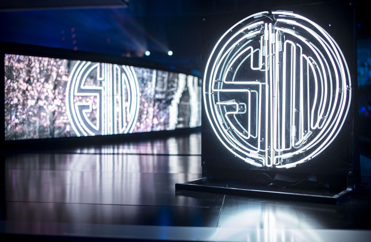 A lit up, neon TSM logo on stage.