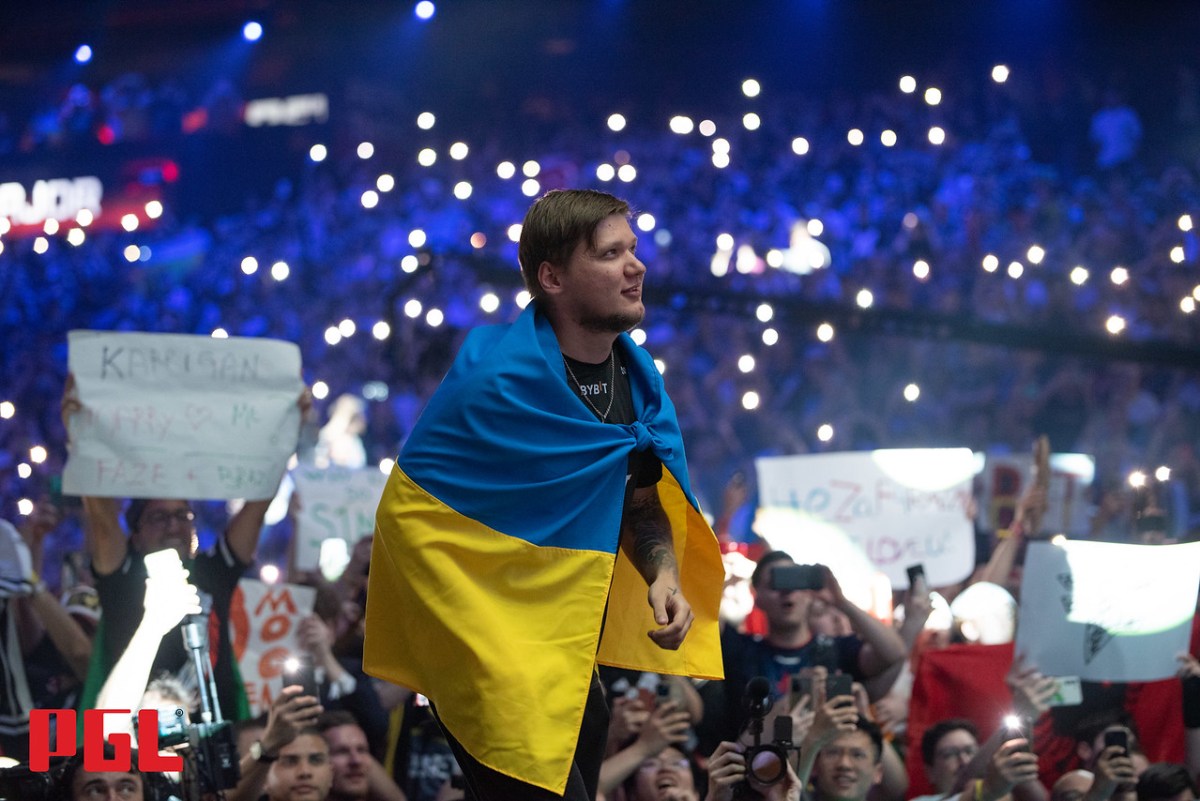 s1mple, draped in the Ukraine flag, walks on stage at the PGL Antwerp Major grand final.