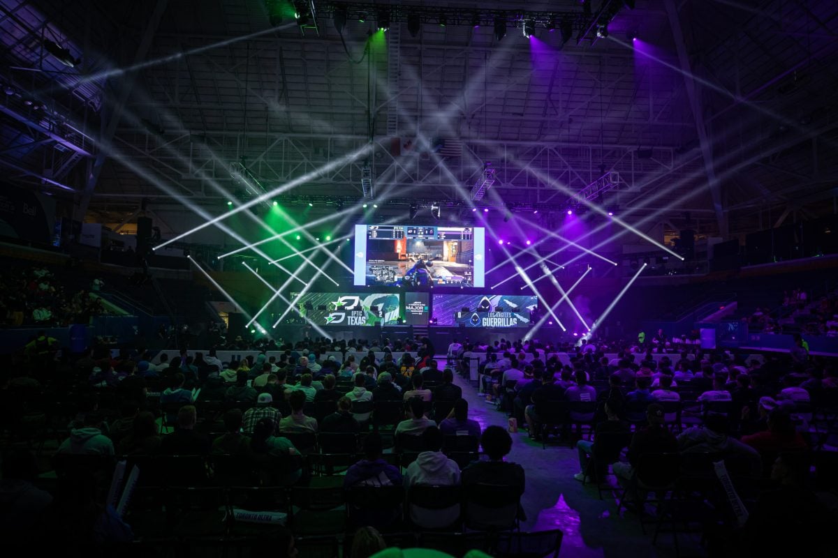OpTic vs LAG in the CDL from the crowd's perspective, looking at the logos on stage.