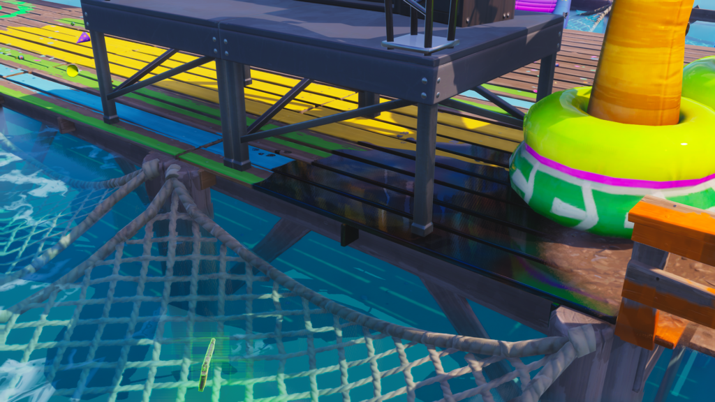 A screengrab from Fortnite showing a pool of dark and somewhat shiny goo underneath a stage