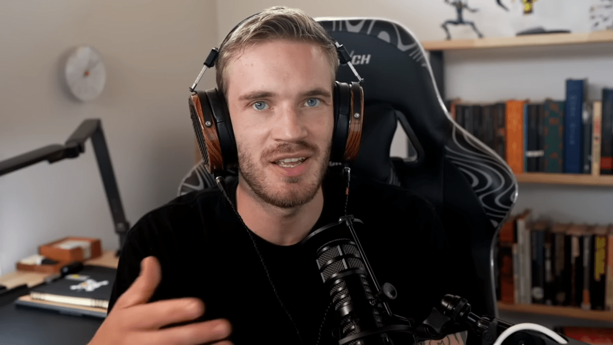 Pewdiepie talking into a microphone at his streaming setup.