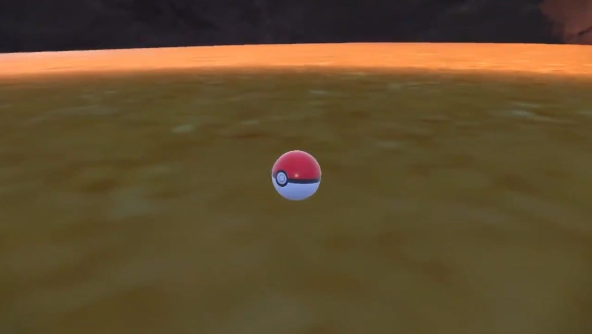 A Poké Ball sitting on the ground.