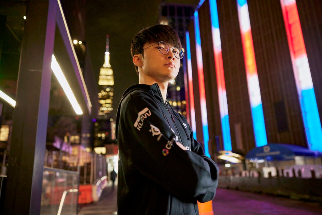 Faker standing in front of Madison Square Garden, with the Empire State Building in the background.