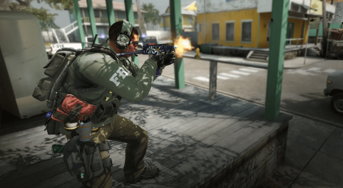 A soldier stands crouched firing a weapon in an open area in Counter-Strike: Global Offensive.