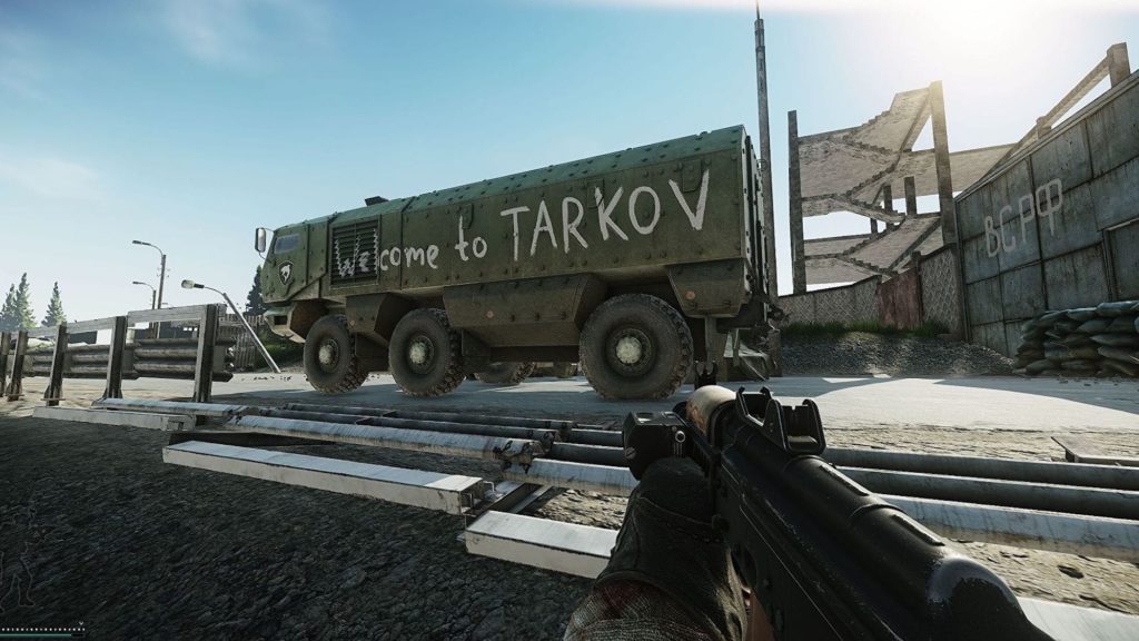 A player looking at a vehicle that says "Welcome to TARKOV" on the side of it in Escape From Tarkov.