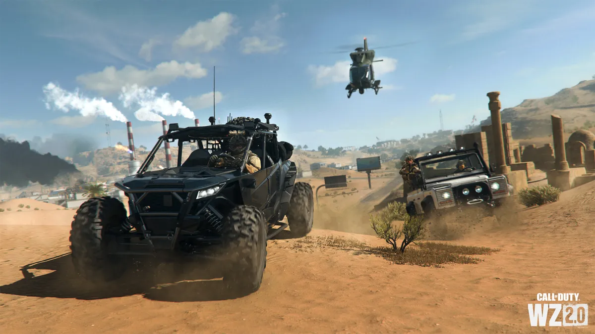 Two vehicles driving in Warzone, followed by a helicopter in the air.