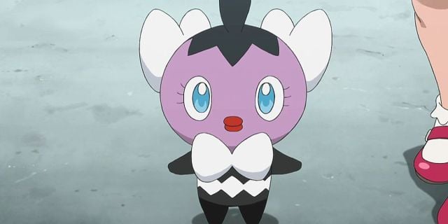 Gothita Pokémon from the anime next to a standing character's shoes.