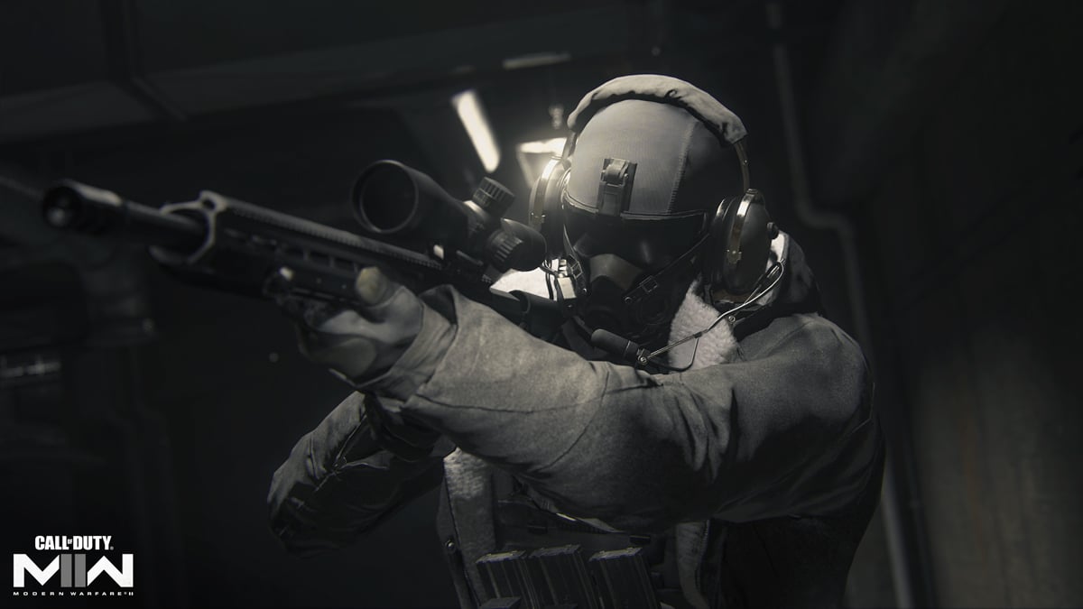 A soldier in black tactical gear aims into a sniper rifle in Call of Duty.