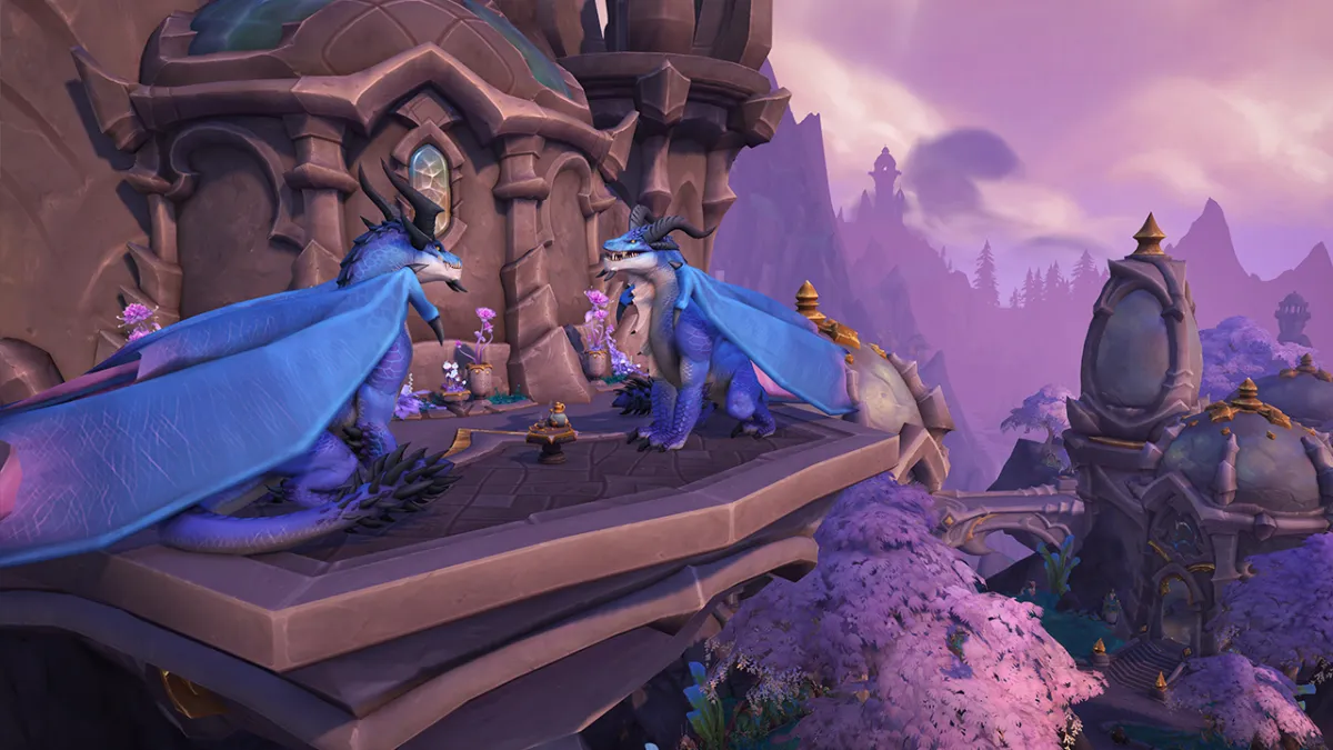 Two blue dragons perched above Valdrakken in WoW Dragonflight
