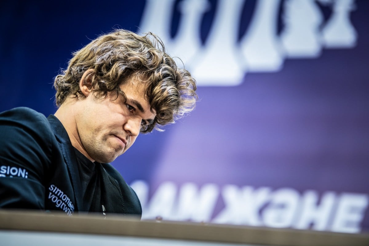 Magnus Carlsen inspects a chess move during a rapid event.