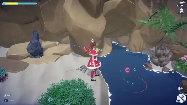 A player dressed in a festive red outfit holding a fishing rod next to a red and green ripple spot in Disney Dreamlight Valley.