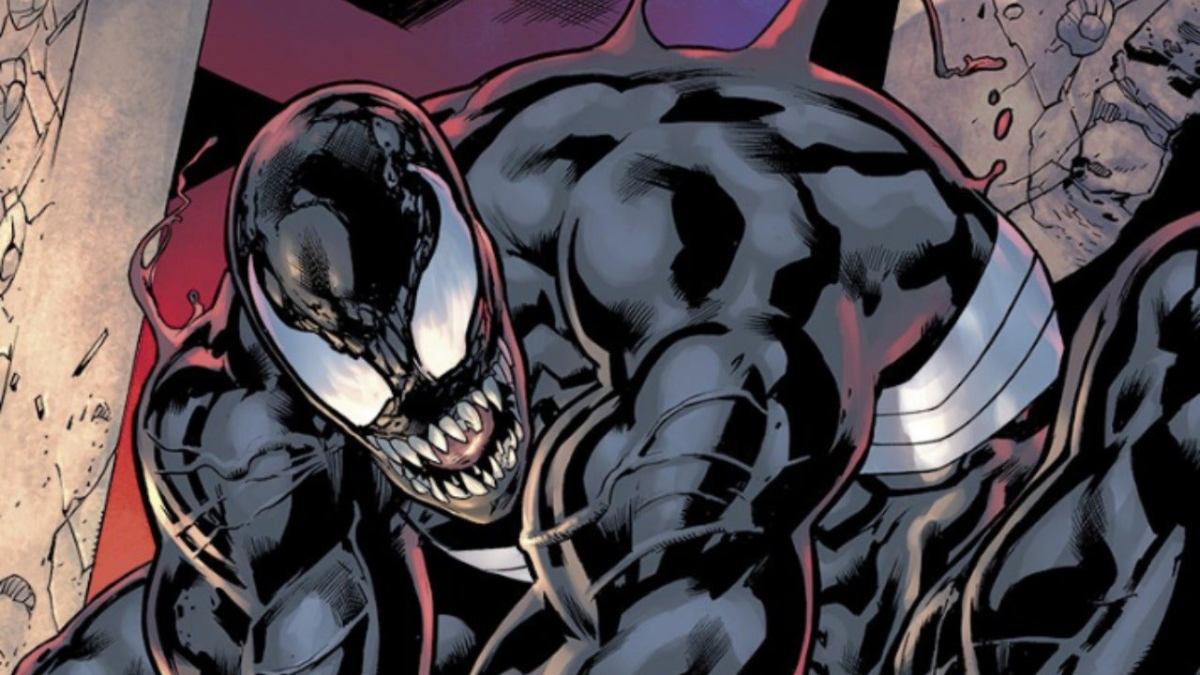 Venom, a villain wearing a black outfit and showing his sharp white teeth, attacks in the comics.