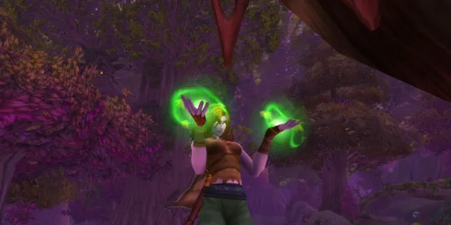 Druid casting a spell with green glowing hands in Teldrassil World of Warcraft.