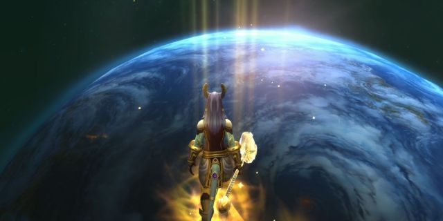 Paladin Draeni glowing gold in World of Warcraft standing over an image of a world.