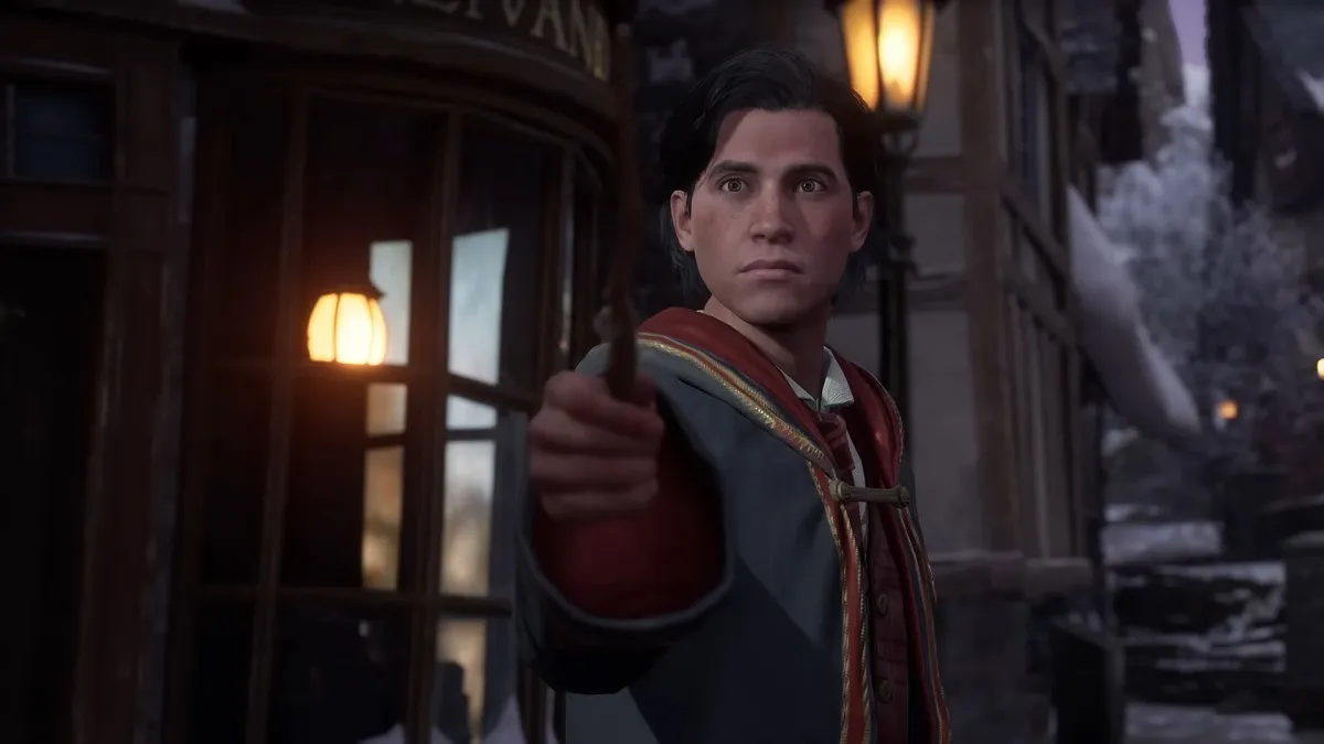 A player character wizard pointing toward the camera with their wand in Hogwarts Legacy.