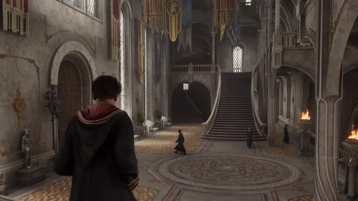 A player character walking through the halls of Hogwarts in Hogwarts Legacy.