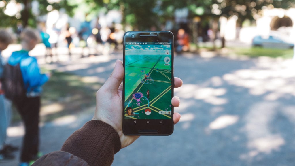 A player displaying Pokémon Go on their phone while out and about.