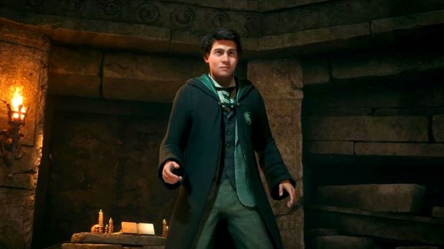 A student at Hogwarts wearing a green and black robe.