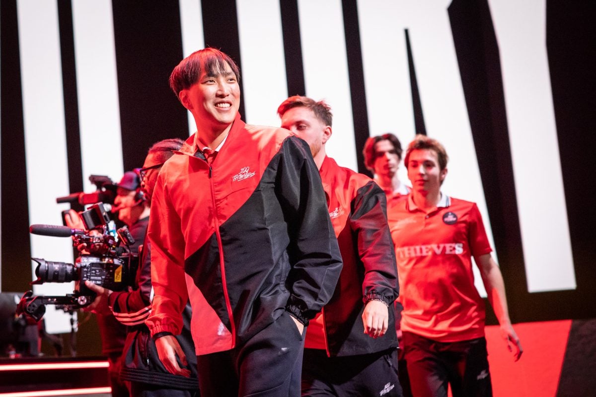 Doublelift stares off into the crowd at the LCS studio in 2023 wearing a 100T jersey