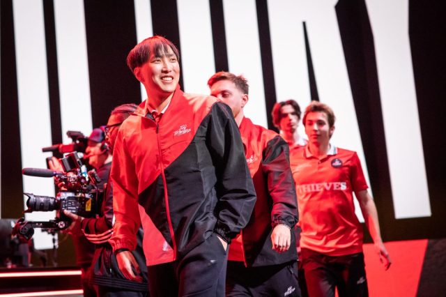 Doublelift stares off into the crowd at the LCS studio in 2023 wearing a 100T jersey