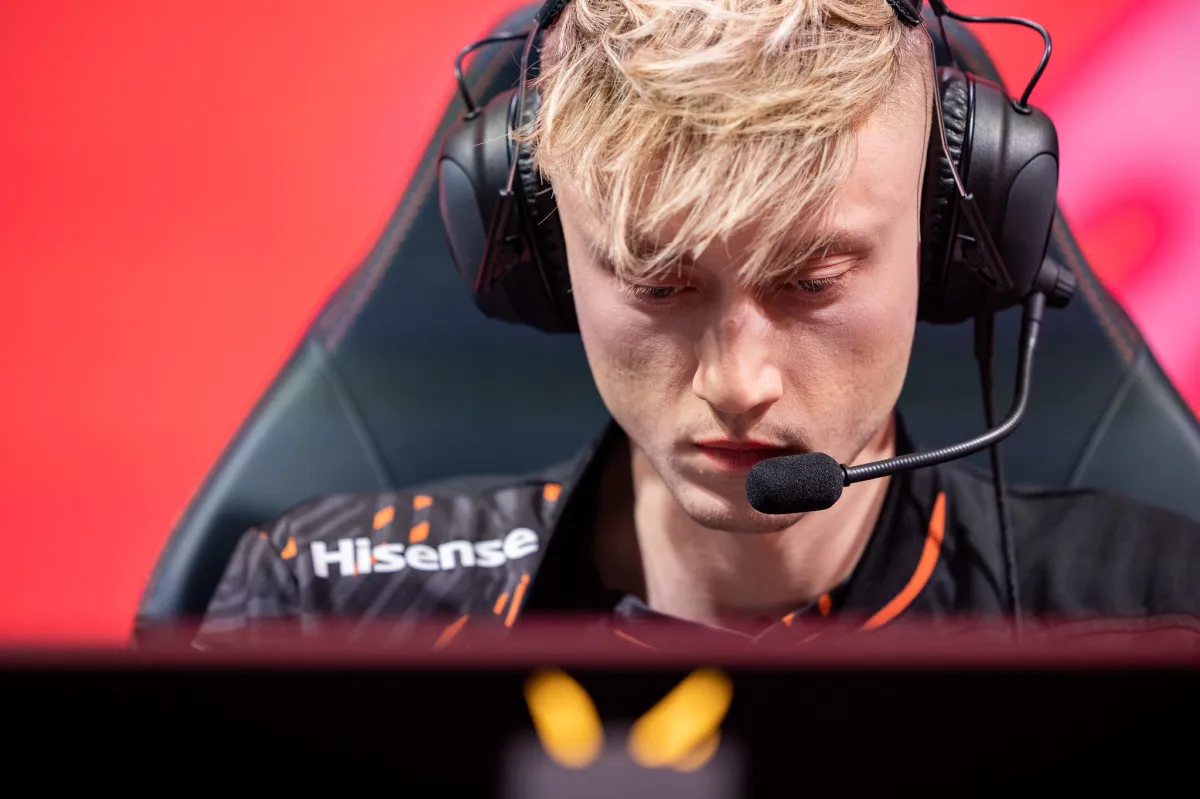 Photo taken of League of Legends pro Rekkles during a LEC match in 2023. He has short blonde hair and is staring at his monitor with headsets on.