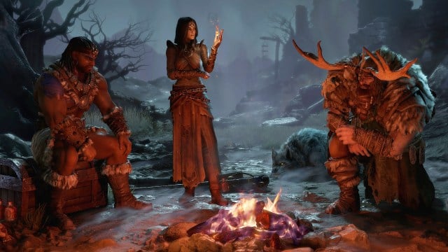 Three Diablo 4 adventurers talk around a burning fire.