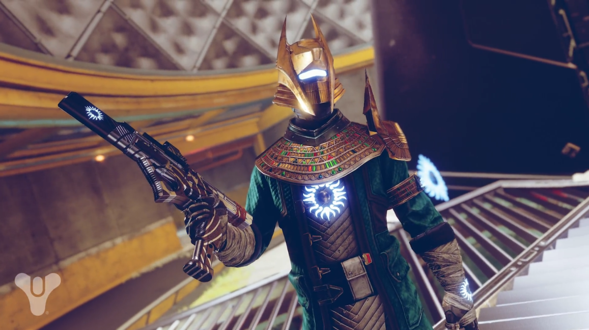 A warlock in Trials of Osiris armor is posing with a Trials submachine gun on the map Javelin-4. Their armor has a partial blue glow.