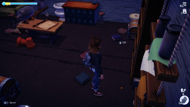 The player looking at a pebble near a shelf. 