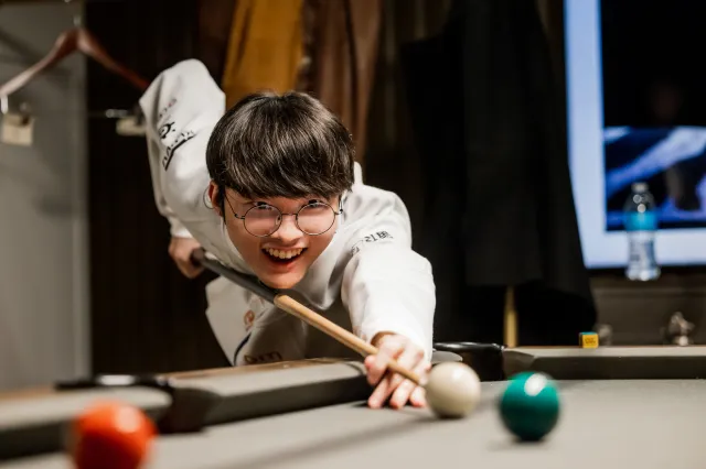 Faker, the greatest League of Legends player of all time, playing pool.