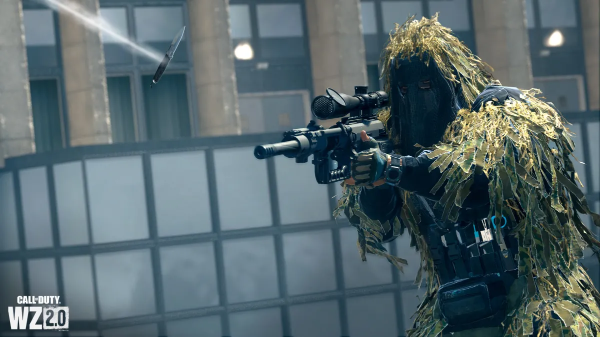 Warzone 2.0 promo image with a player holding a rifle and wearing a ghillie suit