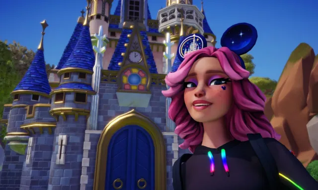 The player wearing Touch of Magic ears and taking a selfie in front of a castle.