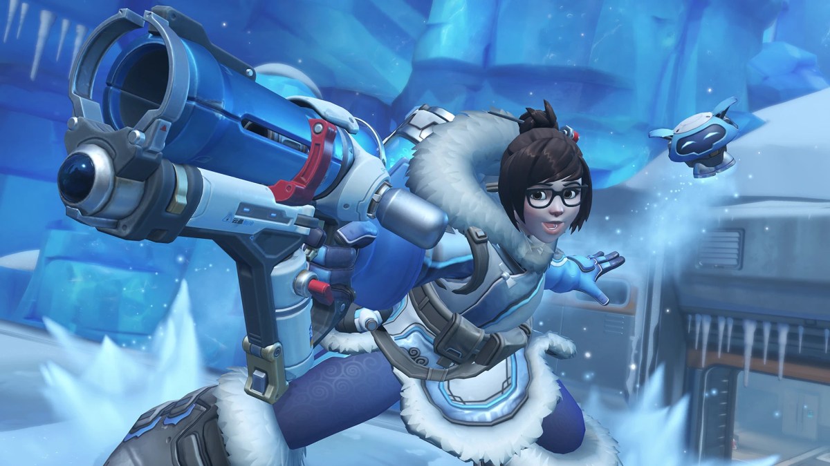 Mei, a scientist in a large warm cloak, stands posing with her ice gun in a frozen scientific base in Overwatch