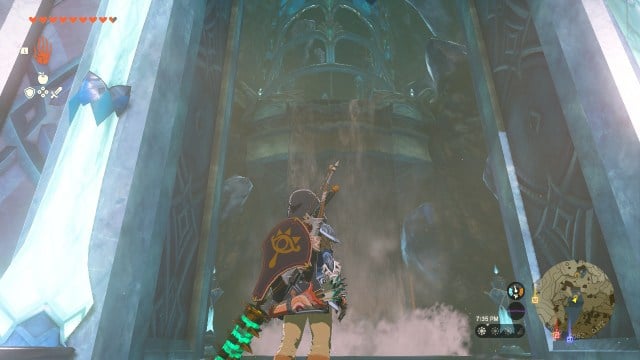 Link stands in front of a waterfall, which hides a secret entrance. Through the archway is a crystal palace.