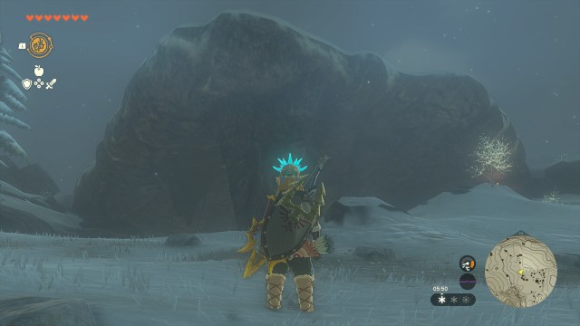 Link standing in front of a large rock outcrop.