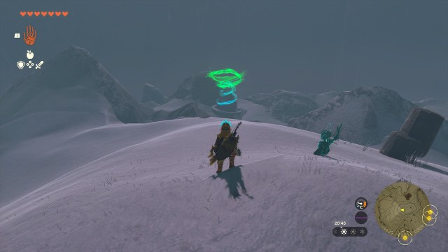 Link looking down a snowy slope to a shrine.